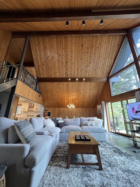 Interior (2nd level) with wall of windows and soaring ceilings 