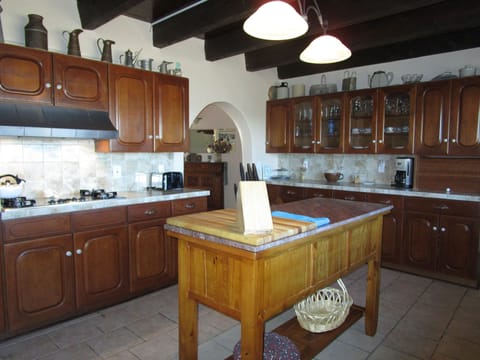 Kitchen equipped with plenty of cooking gear, toaster, blender & coffee maker.  