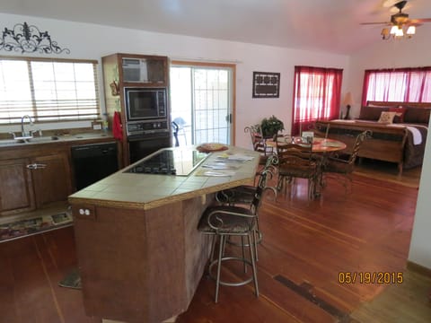 The House kitchen, dining & on to 2 king beds