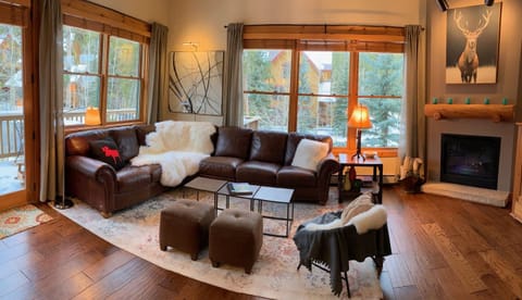 Seating and fireplace in the great room. Banks of windows on south & east walls.