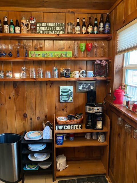 Coffee station and shelves for glasses and mugs.