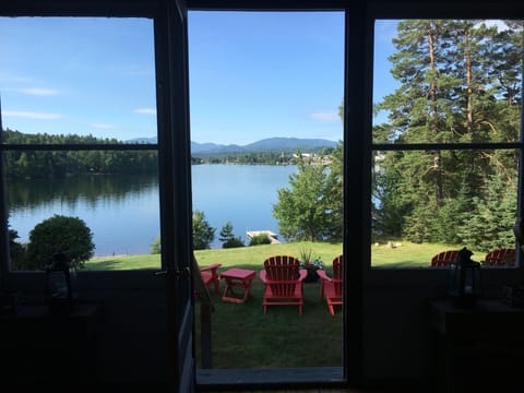Looking out the front door: porch overlooks lawn, swimming dock and lake.