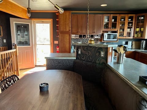 Wonderful new banquette comfortably seats 7.  Main entry door is showing.