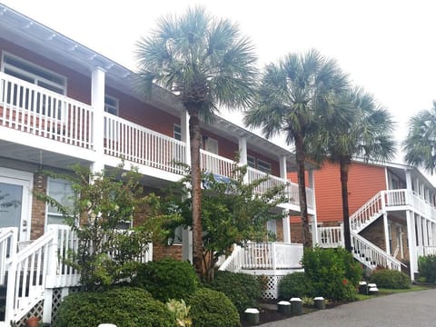 Upstairs unit - door can be seen between the palms