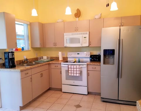 Kitchen with stove, range, fridge, ice maker, coffee maker, toaster, etc