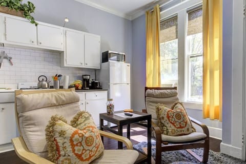 Smartly designed open-concept space combining kitchen, dining, and living areas—sun-drenched filled with natural light, creating a bright and uplifting atmosphere.