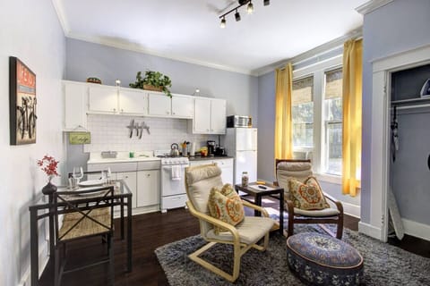 Smartly designed open-concept space combining kitchen, dining, and living areas—cozy, functional, and full of character.