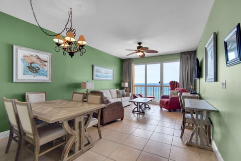 Living Room - Step into coastal living with this airy beachfront living room, boasting cozy seating, a large flat-screen TV, and endless ocean views for total comfort.