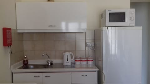 Kitchenette with provided tea, coffee,  bottled water, fresh milk upon arrival.