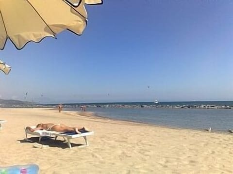 Uncluttered beach in the luxury private resort a short walk from the apartment