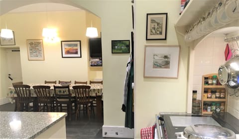 Kitchen with kitchen table through arch
