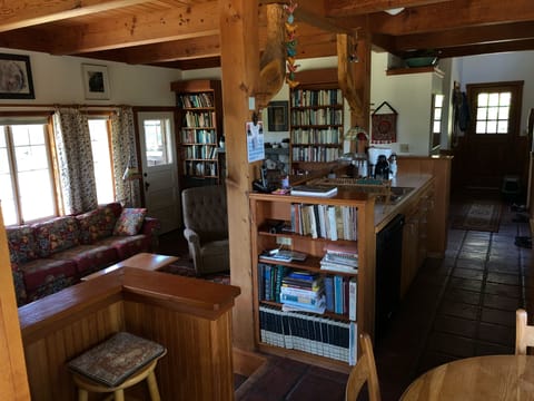 View from side porch into living room, kitchen, and dining area