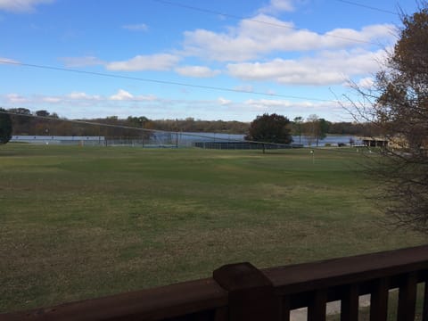 view of golf course and lake at country club