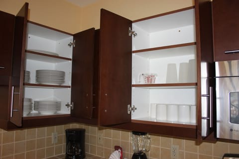 Stocked with Dishes, plates, cups, and all the necessities for cooking