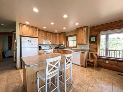 Cozy kitchen with island and rustic charm, perfect for gathering, cooking, and enjoying scenic mountain views