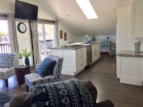 Open concept and view of patio doors to private balcony 