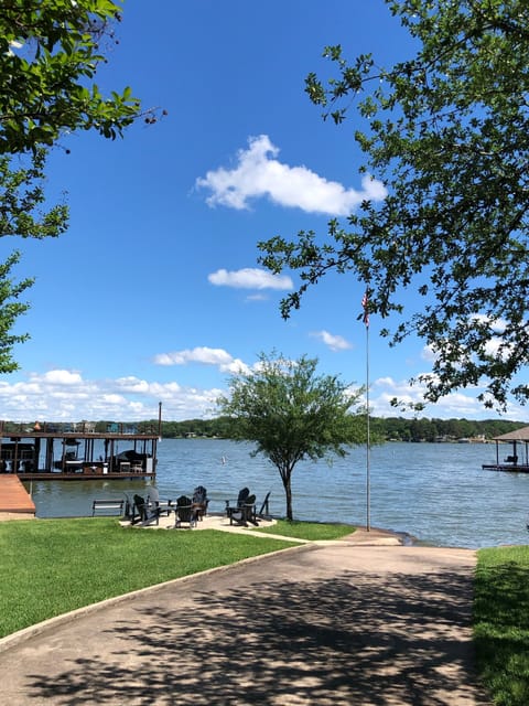boat ramp, water view, dock to left and fire pit
