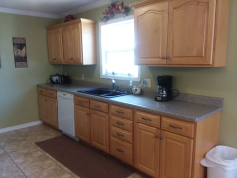 Kitchen (right) has essential dishes, small appliances, and cleaning supplies.