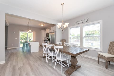 Large dining table flowing into luxurious kitchen.  