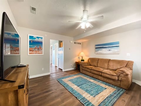 Bright living room with cozy seating and large TV for relaxing evenings