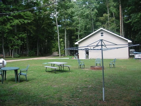 Back yard fire pit, clothes line and picnic table and parking in front of garage