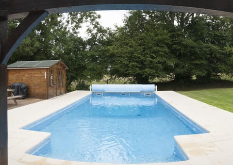 Heated swimming pool (optional extra in summer months), with full safety cover.