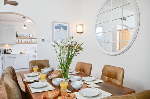 Dining area with locally crafted table and leather chairs