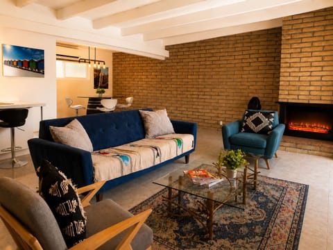 Cozy living area featuring a Smart TV  and an ambient electric fireplace perfect for relaxing. 