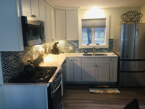 Updated kitchen with quartz counter tops&tile backsplash w/ full size appliances
