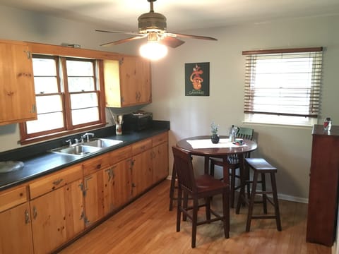 Full kitchen with 4-burner gas stove, oven, full fridge.