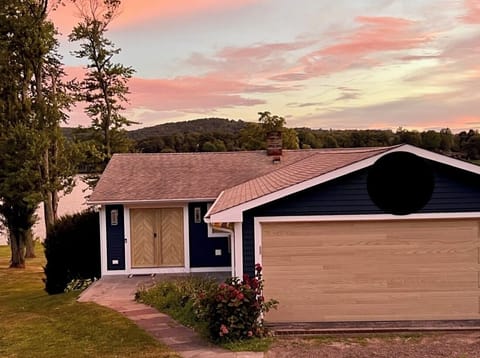 View from street to front of the house, automated garage and keyed door entry