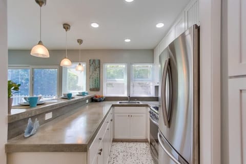 Gas stove, microwave and large stainless steel refrigerator.