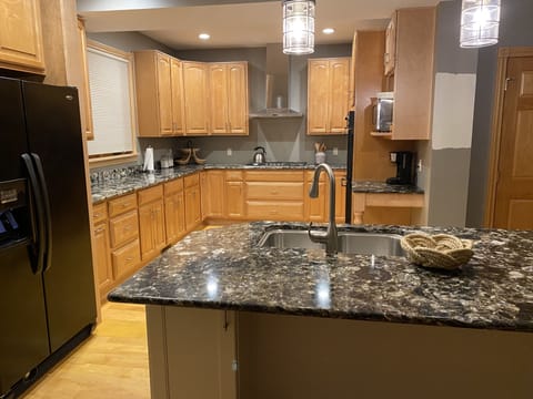 Kitchen with island, office, double ovens and chef style gas Bosch stove top