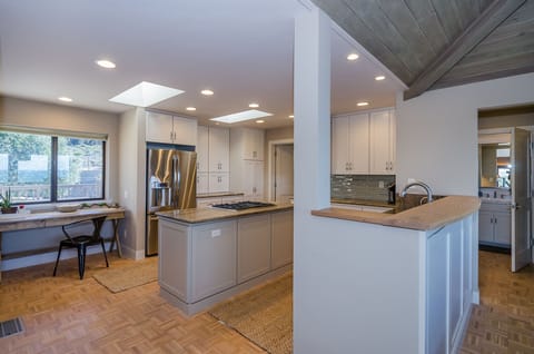 This view of the kitchen shows an extra table to the far left - great for office