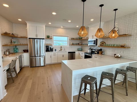 Fully stocked luxury kitchen with ocean views out of the window.