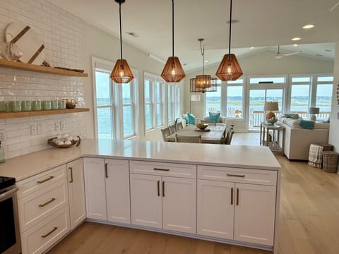 Watch dolphin jump and boats go by while cooking a feast