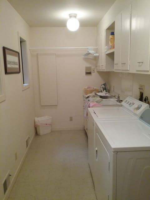 Fully equipped laundry facilities with iron and ironing board