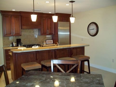 Gourmet Kitchen equipped with pots, pans, dishes and small appliances.