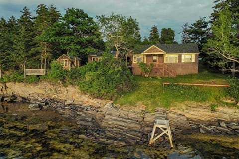 View of the cottage and the rocky shoreline, just steps away. 

(No dock)