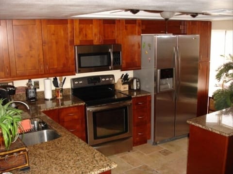 Kitchen features stainless and granite
