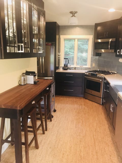 Super bright kitchen with breakfast bar, cork flooring.