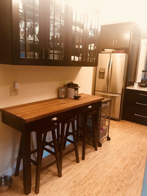 French door refrigerator and lighted glasses cabinet.