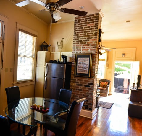 From kitchen table toward living room. Front door opens to reveal courtyard.