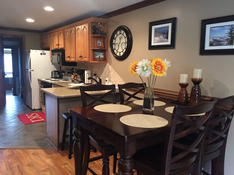 New Ashley dining table seats 4, with 2 additional barstools at the counter