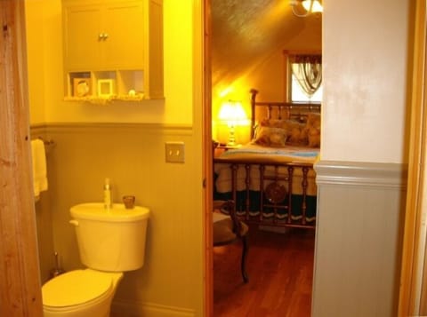 bath and bedroom with antique brass bed