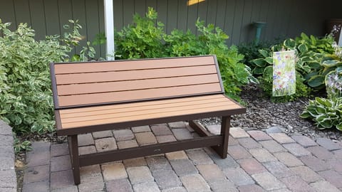 Small bench for sitting in the patio & flower garden area.