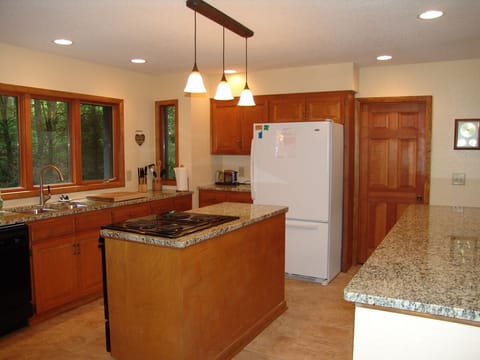Open kitchen with a lot of light and an additional refrigerator in the pantry