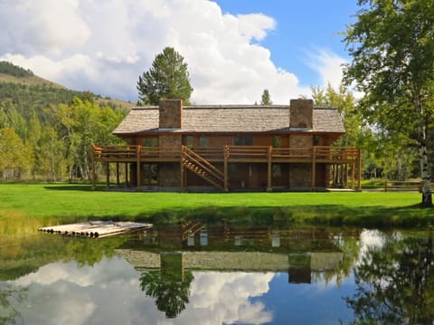 Custom built log cabin with pond situated on 4 pristine acres