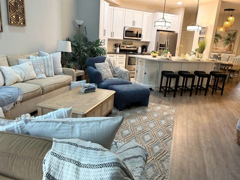 Open Living Area with 75" big screen tv and easy access to the kitchen.