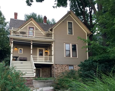 View of house and apartment from the street.  Apt entry to right of stairs.